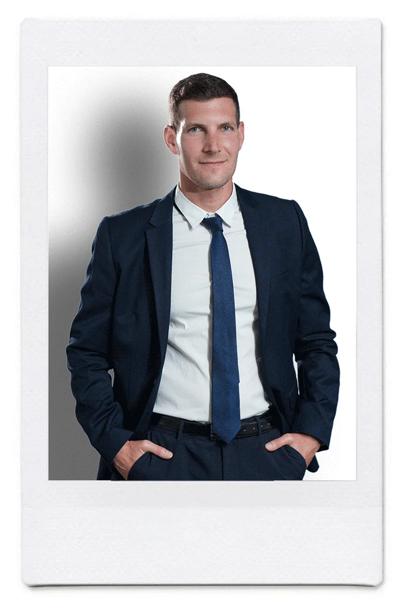 Portrait of Ricardo Martin, European Patent Attorney at Katzarov SA, wearing a dark suit and standing confidently with hands in pockets.